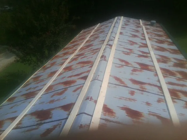Rusted metal roof panels with new wood purlins before replacement — Storm Damage Roof Repair in Clarksburg by Roofing Brothers